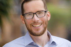 sydney-corporate-outdoor-headshot-glasses-light-shirt-matthew-with-a-camera