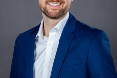 sydney-corporate-portrait-blue-suit-clasped-hands-matthew-with-a-camera